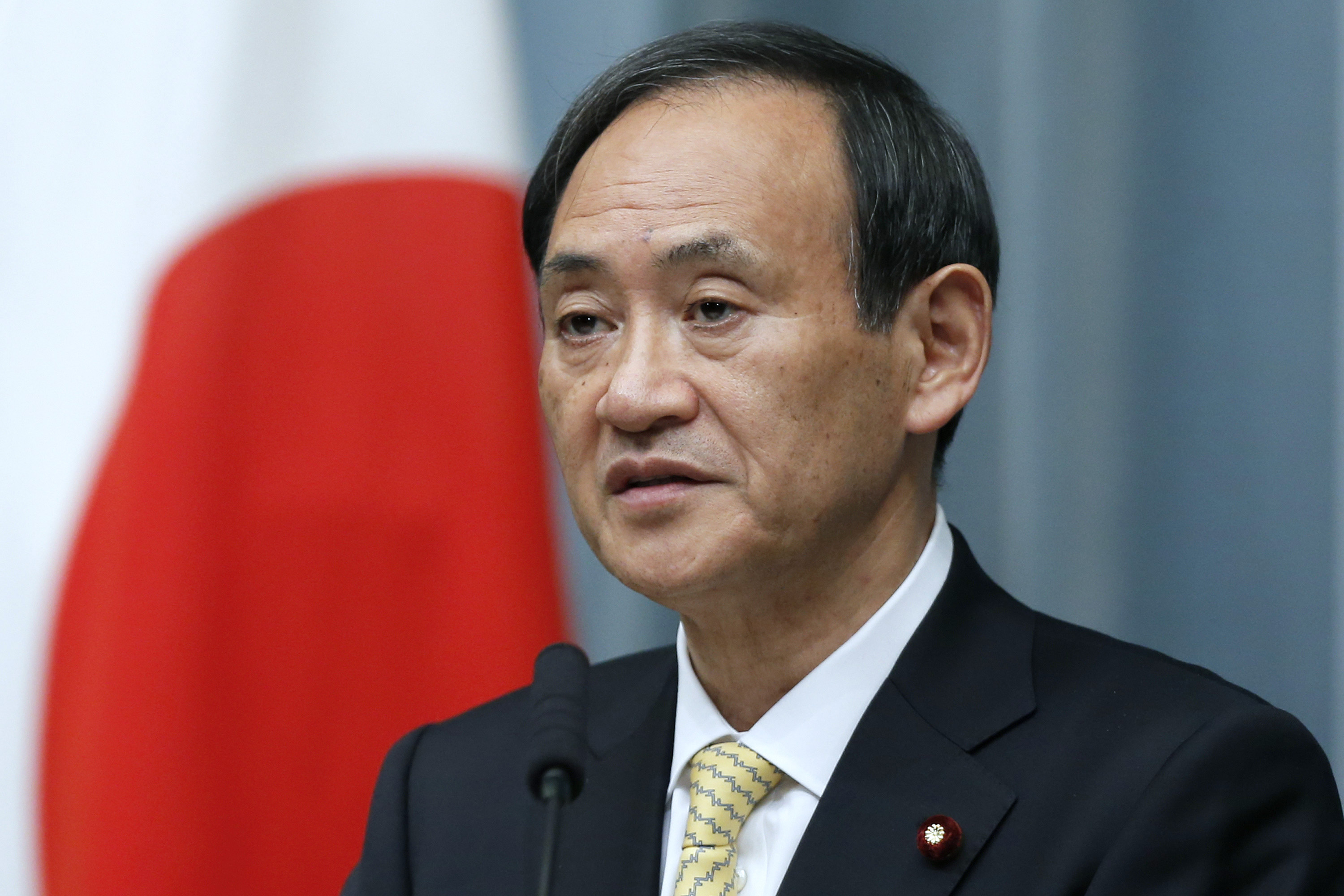 Yoshihide Suga, Japan\'s newly named chief cabinet secretary, speaks during a news conference at the prime minister\'s official residence in Tokyo, Japan, on Wednesday, Dec. 26, 2012. Japan\'s parliament confirmed Shinzo Abe as the nation\'s seventh prime minister in six years, returning him to the office he left in 2007 after his party regained power in a landslide election victory last week. Photographer: Kiyoshi Ota/Bloomberg *** Local Caption *** Yoshihide Suga