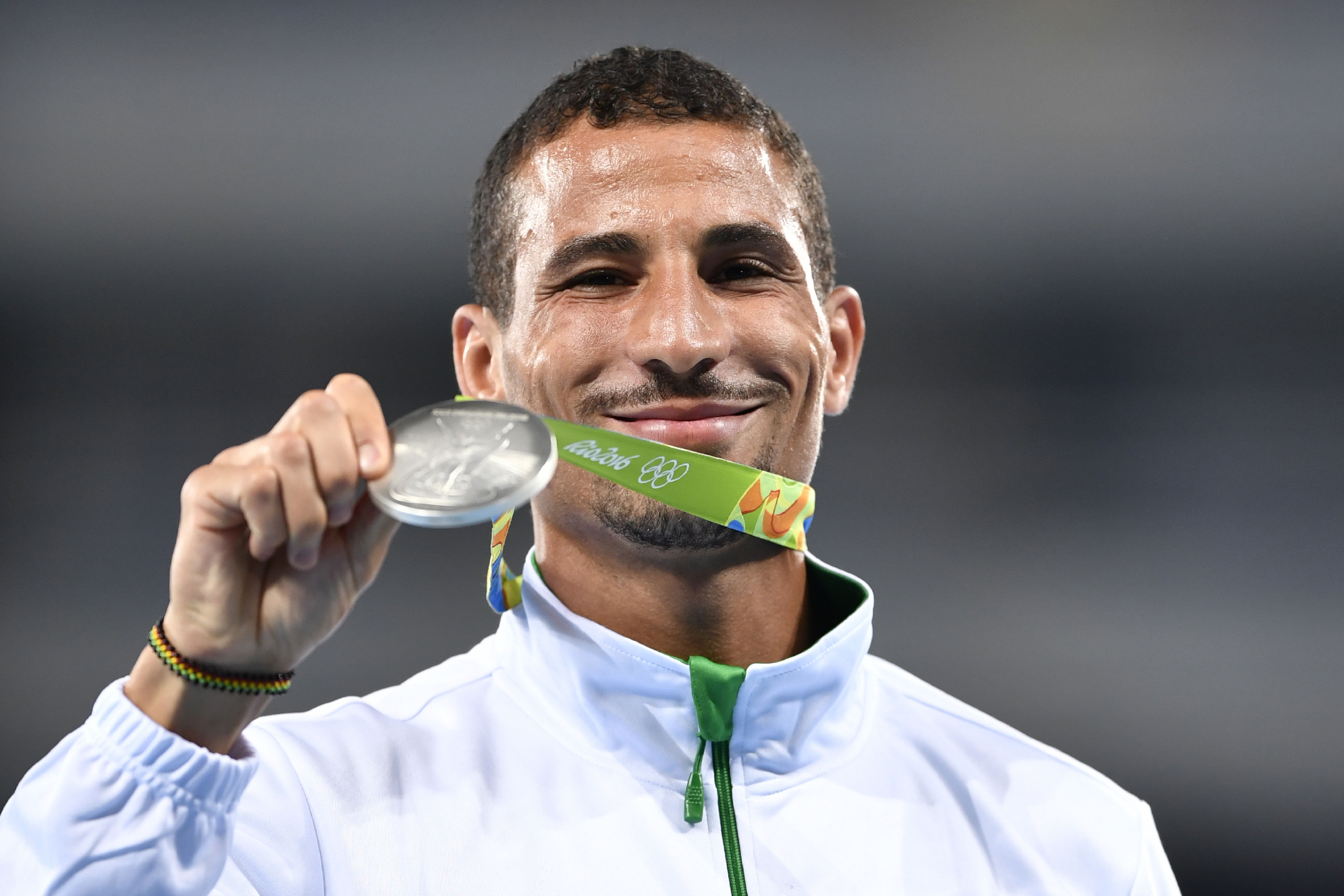 Silver medallist Algeria\'s Taoufik Makhloufi celebrates on the podium for the Men\'s 800 meter during the athletics at the Rio 2016 Olympic Games at the Olympic Stadium in Rio de Janeiro on August 16, 2016.   / AFP / Fabrice COFFRINI        (Photo credit should read FABRICE COFFRINI/AFP/Getty Images)